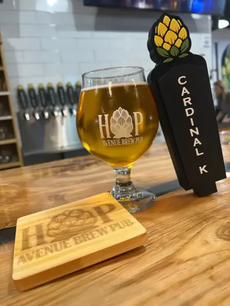 "Cardinal Kolsch next to its custom tap handle at Hop Avenue Brew Pub in Bridge City."
