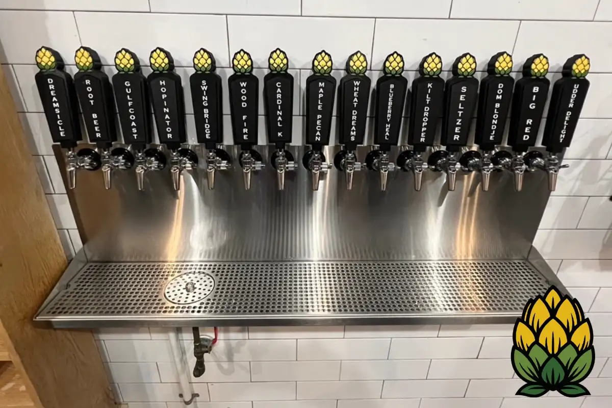 Sixteen craft beer draft taps on a stainless steel wall at Hop Avenue Brew Pub in Bridge City, Texas.