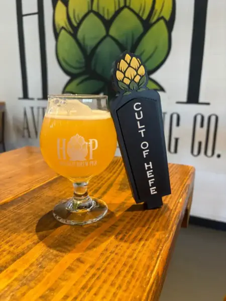 "A fresh pour of Cult of Hefe wheat beer and custom tap handle at Hop Avenue Brew Pub in Bridge City."